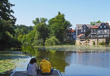 Canoeing on the River Lahn 4 Canoeing on the River Lahn - A couple is sitting on a wooden jetty by the river.
