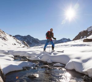 Ski touring for beginners 8 Ski touring for beginners - Ski tourer in the sunshine in the mountains.
