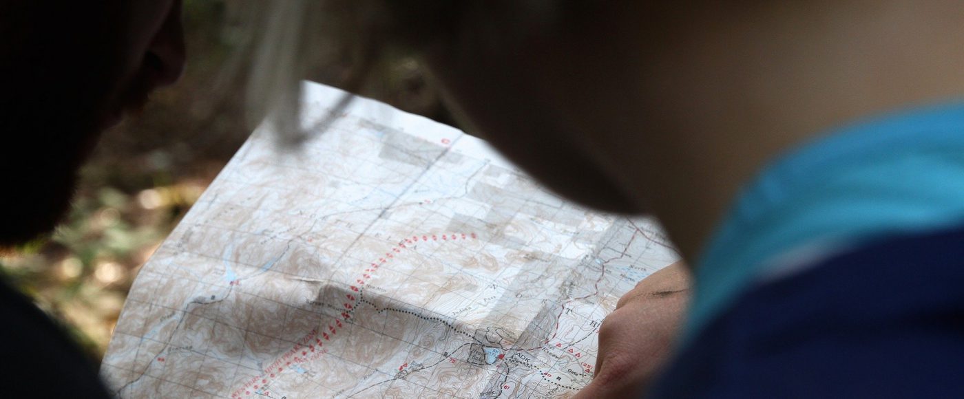 Zwei Wanderer lesen ein Wanderkarte.