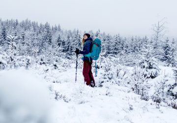 Winter trekking in Sweden: Franziska with her backpack in the snowy forests of Sweden.